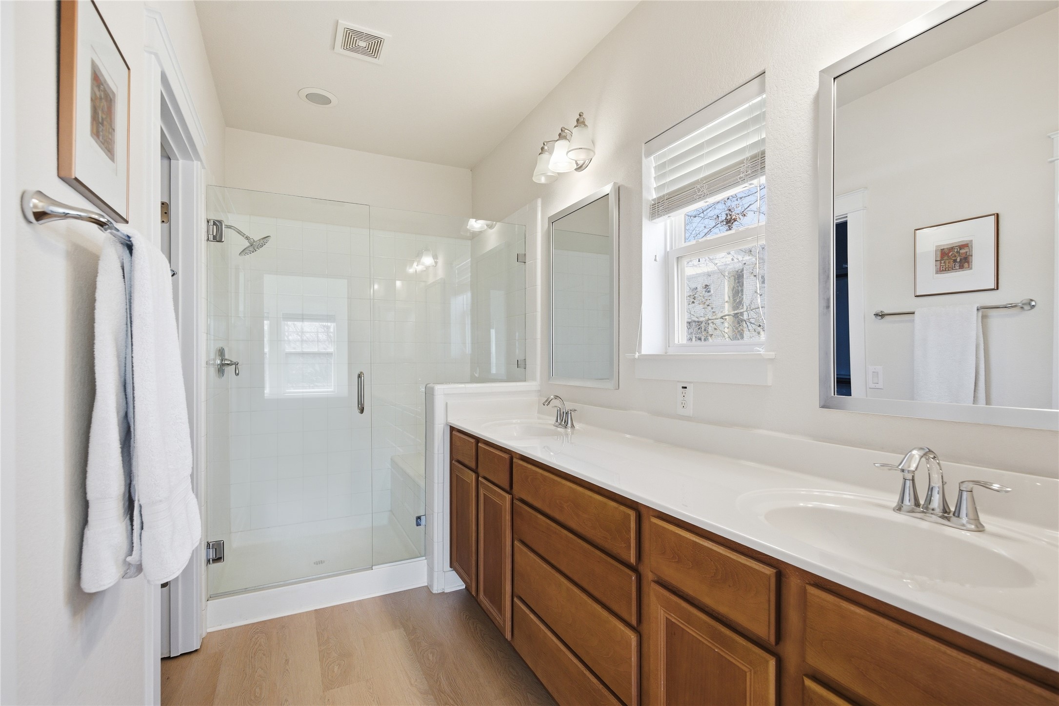 3900 Threadgill Street, Unit 2 Austin, TX 78723 - Photo 13 of 19 The primary en suite bathroom features a double vanity, new Moen shower head and new frameless glass shower door.