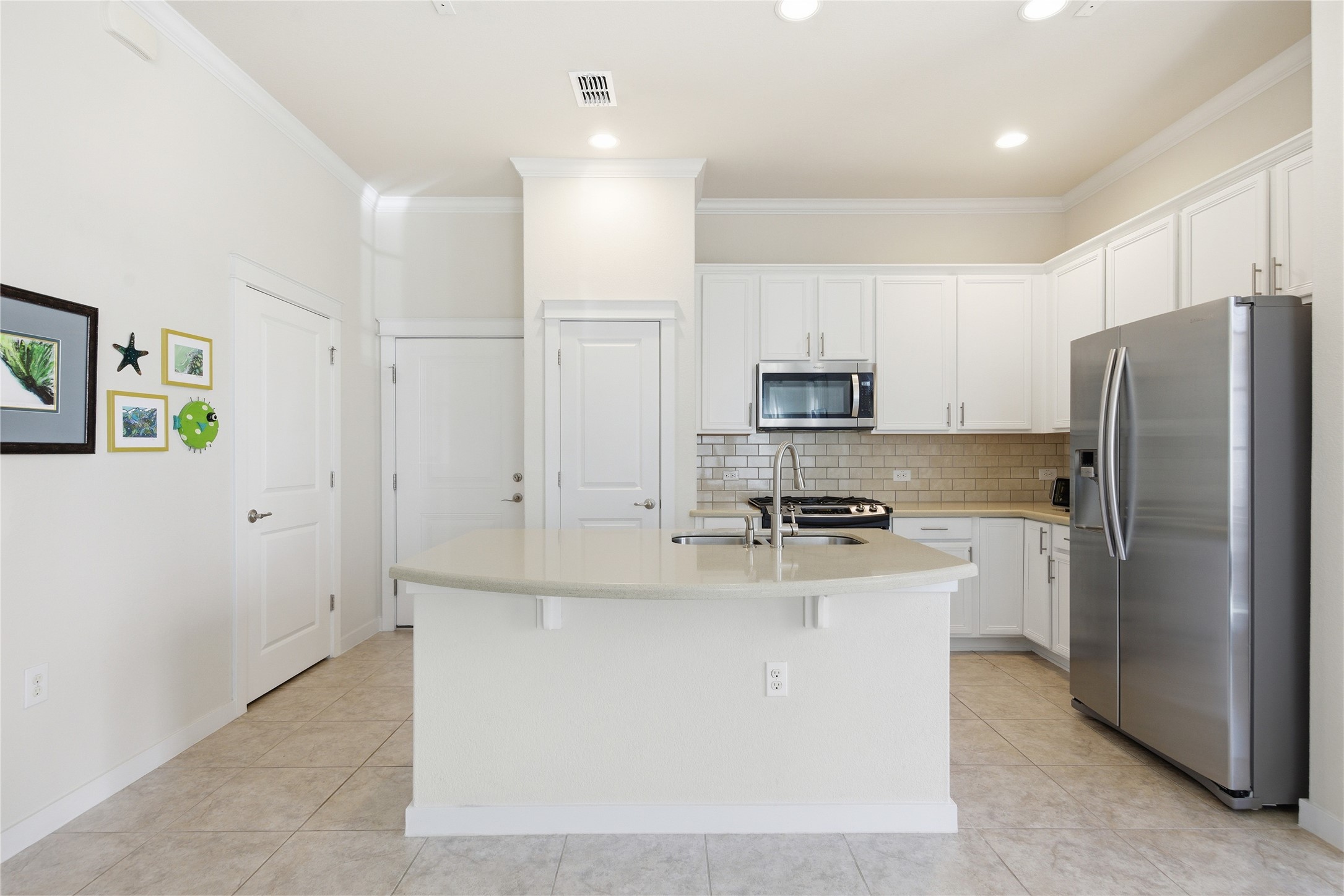 3900 Threadgill Street, Unit 2 Austin, TX 78723 - Photo 7 of 19 A large Corian island and plenty of storage make this kitchen a breeze for cooking.