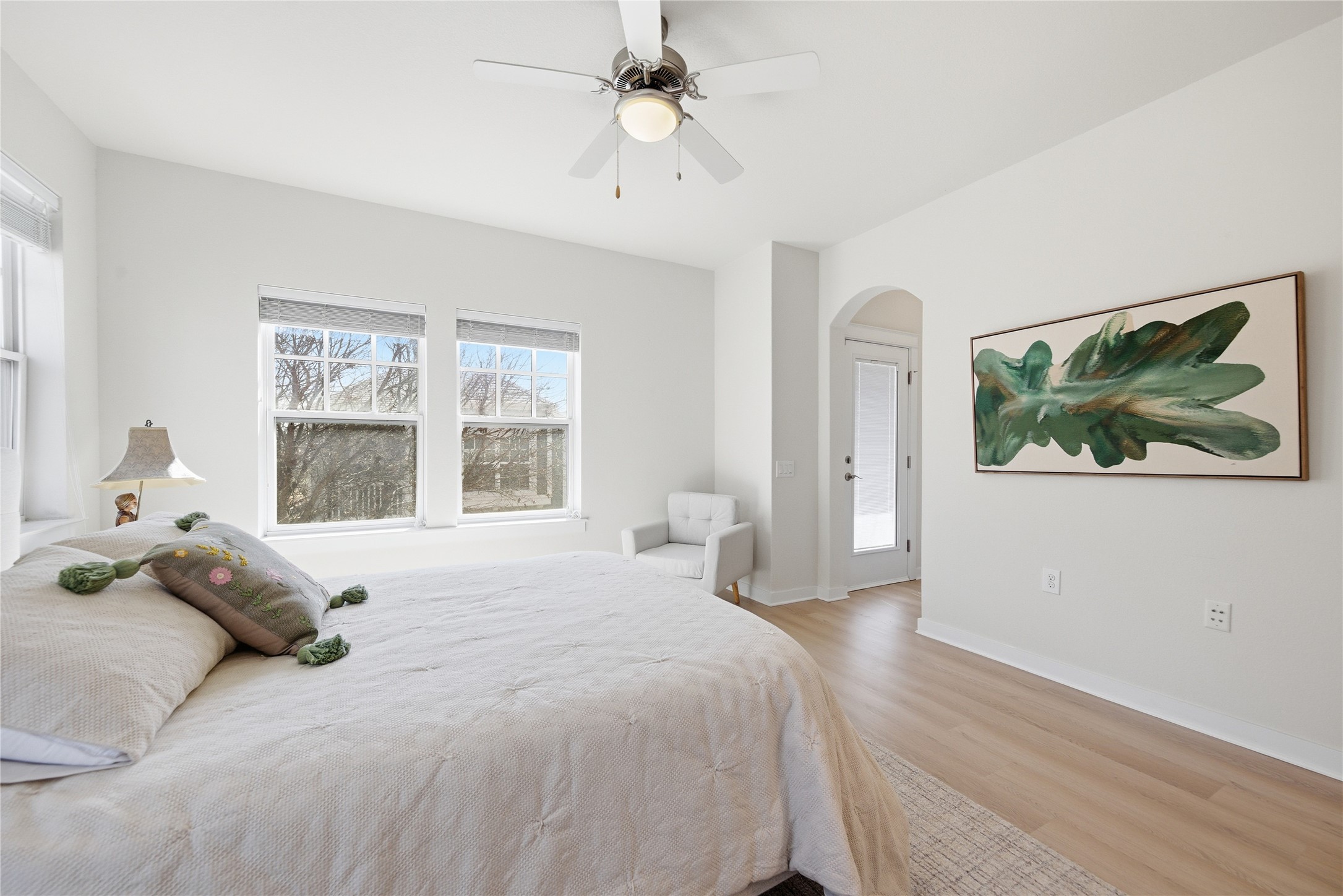 3900 Threadgill Street, Unit 2 Austin, TX 78723 - Photo 10 of 19 Arched walkways, updated LVP flooring, and bright windows in a spacious primary bedroom.