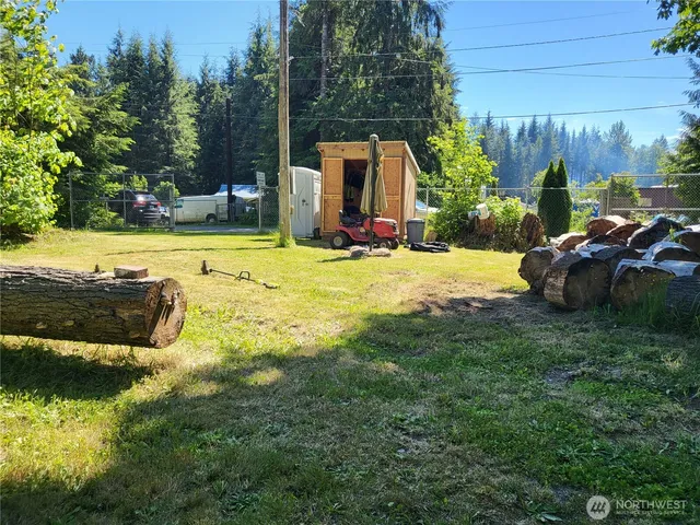 a view of a backyard with swimming pool