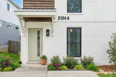 a front view of a house with flowers
