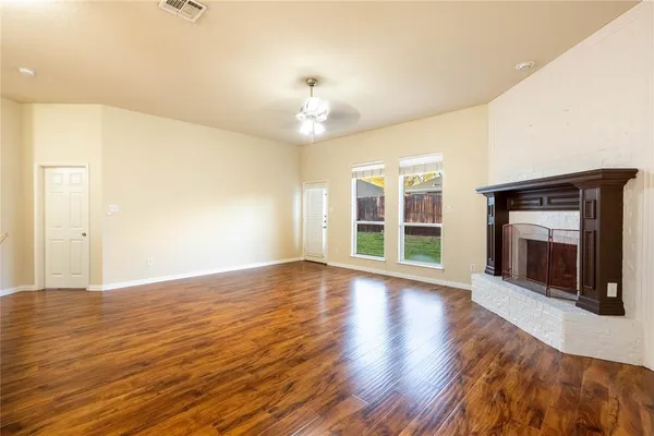 a view of wooden floor and windows in a room