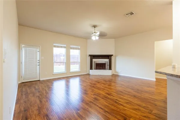 a kitchen with kitchen island granite countertop a stove a sink and a refrigerator
