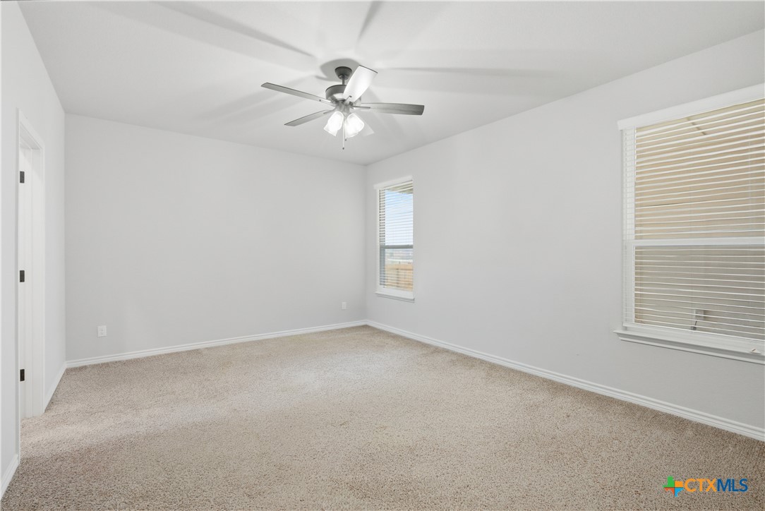 3201 Hedwig Street Killeen, TX 76549 - Photo 15 of 38 an empty room with windows and fan