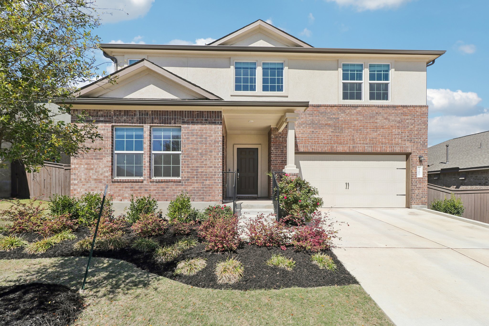 1201 Mallow Road Leander, TX 78641 - Photo 1 of 40 Traditional home with brick siding, concrete driveway, a garage, and stucco siding