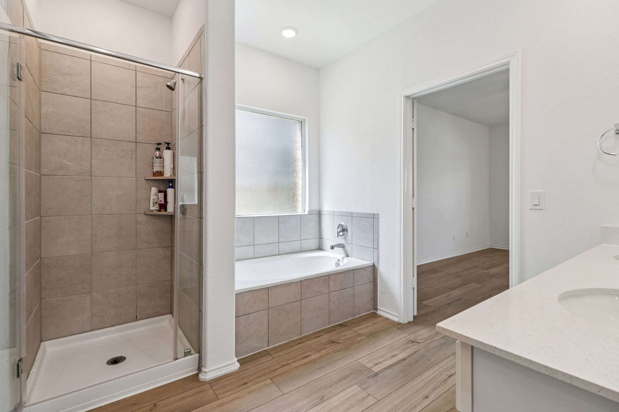 1201 Mallow Road Leander, TX 78641 - Photo 23 of 40 Bathroom with vanity, light wood finished floors, a shower stall, and a bath