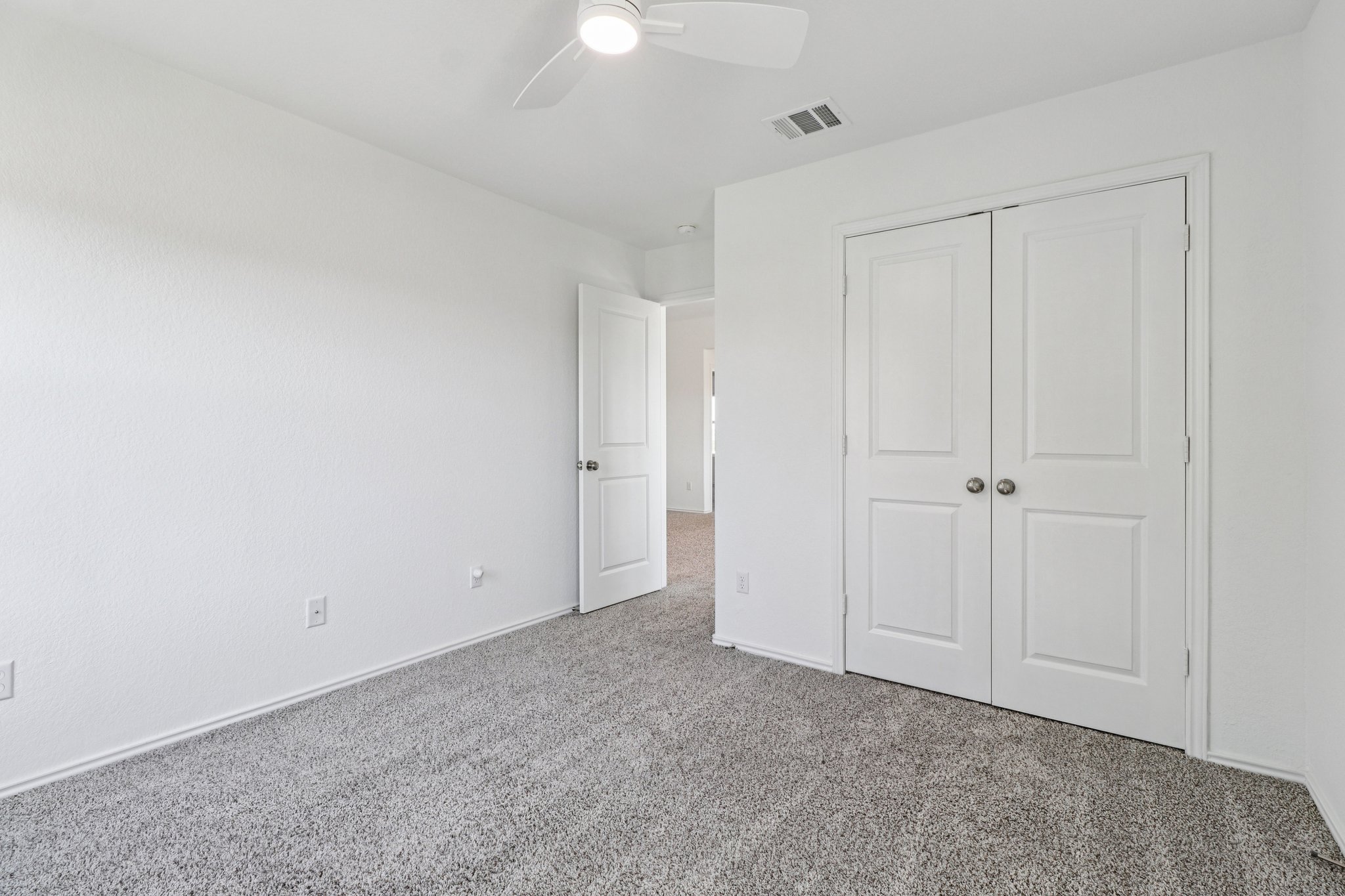 1201 Mallow Road Leander, TX 78641 - Photo 29 of 40 Unfurnished bedroom with carpet flooring, a ceiling fan, and a closet