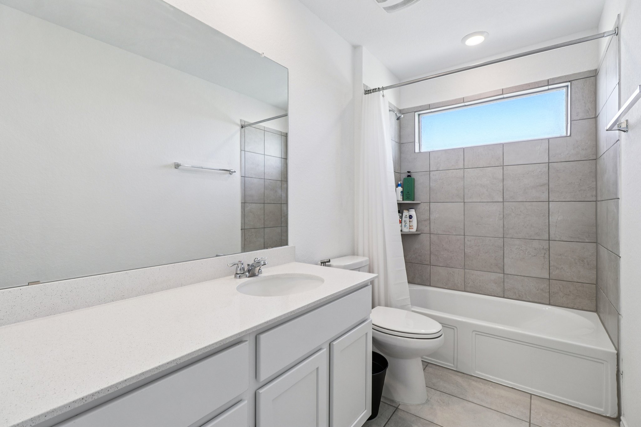 1201 Mallow Road Leander, TX 78641 - Photo 34 of 40 Bathroom featuring vanity, shower / tub combo with curtain, and light tile patterned floors
