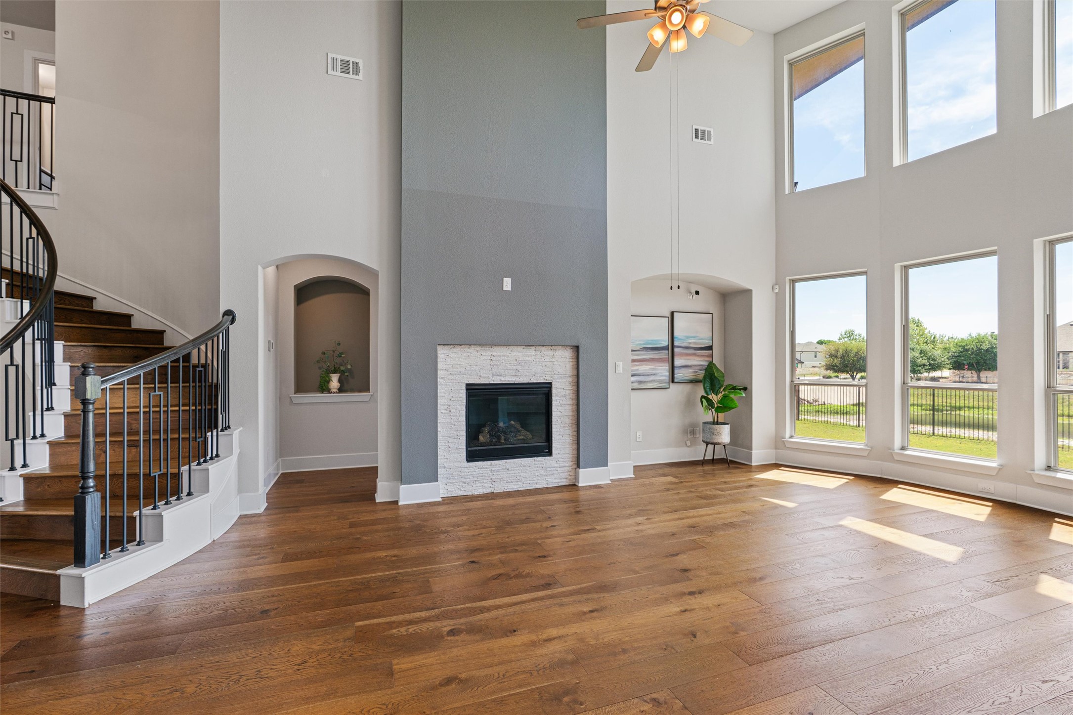 108 Rio Vista Drive Georgetown, TX 78626 - Photo 11 of 40 a view of an empty room with wooden floor and a fireplace