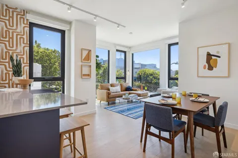 a dining room with wooden floor and a floor to ceiling window