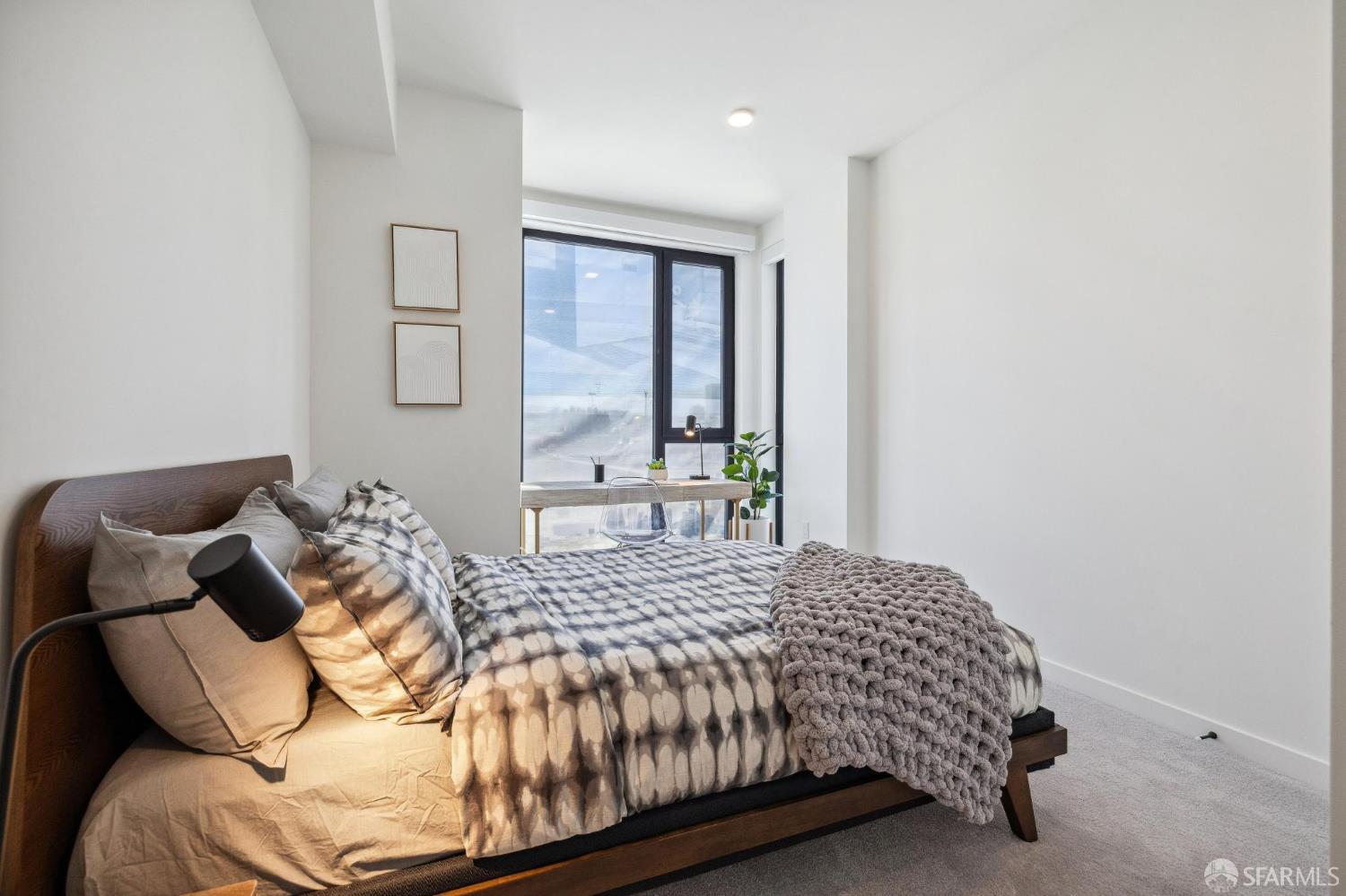 988 Harrison Street, Unit 707 San Francisco, CA 94107 - Photo 12 of 24 a bedroom with a bed and a window