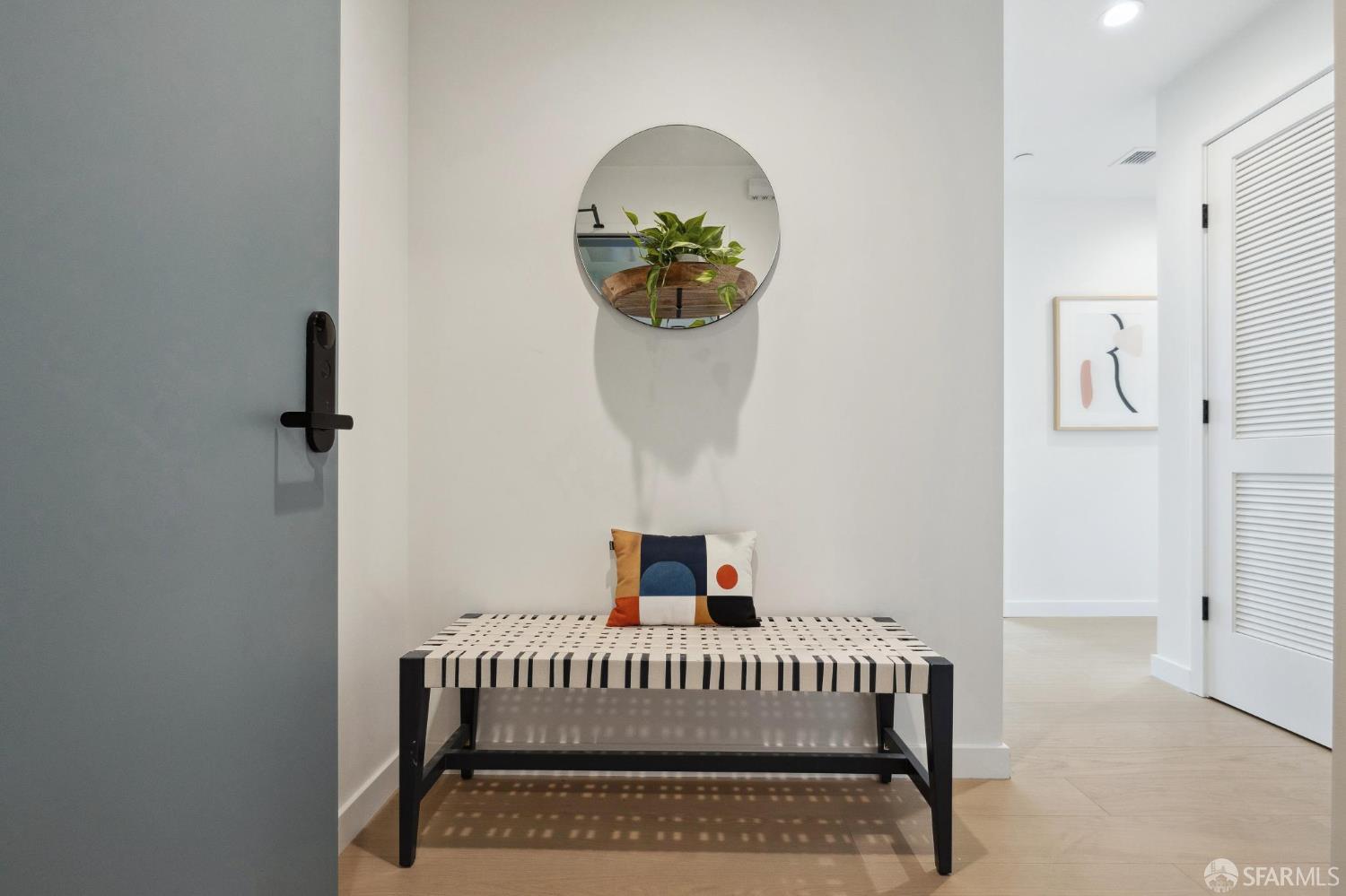 988 Harrison Street, Unit 707 San Francisco, CA 94107 - Photo 2 of 24 a bedroom with a bed and a mirror