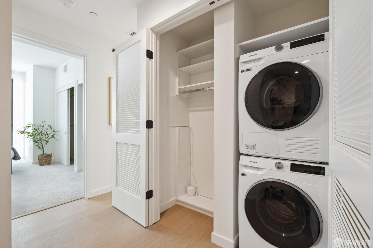 988 Harrison Street, Unit 707 San Francisco, CA 94107 - Photo 3 of 24 a view of a hallway with washer and dryer