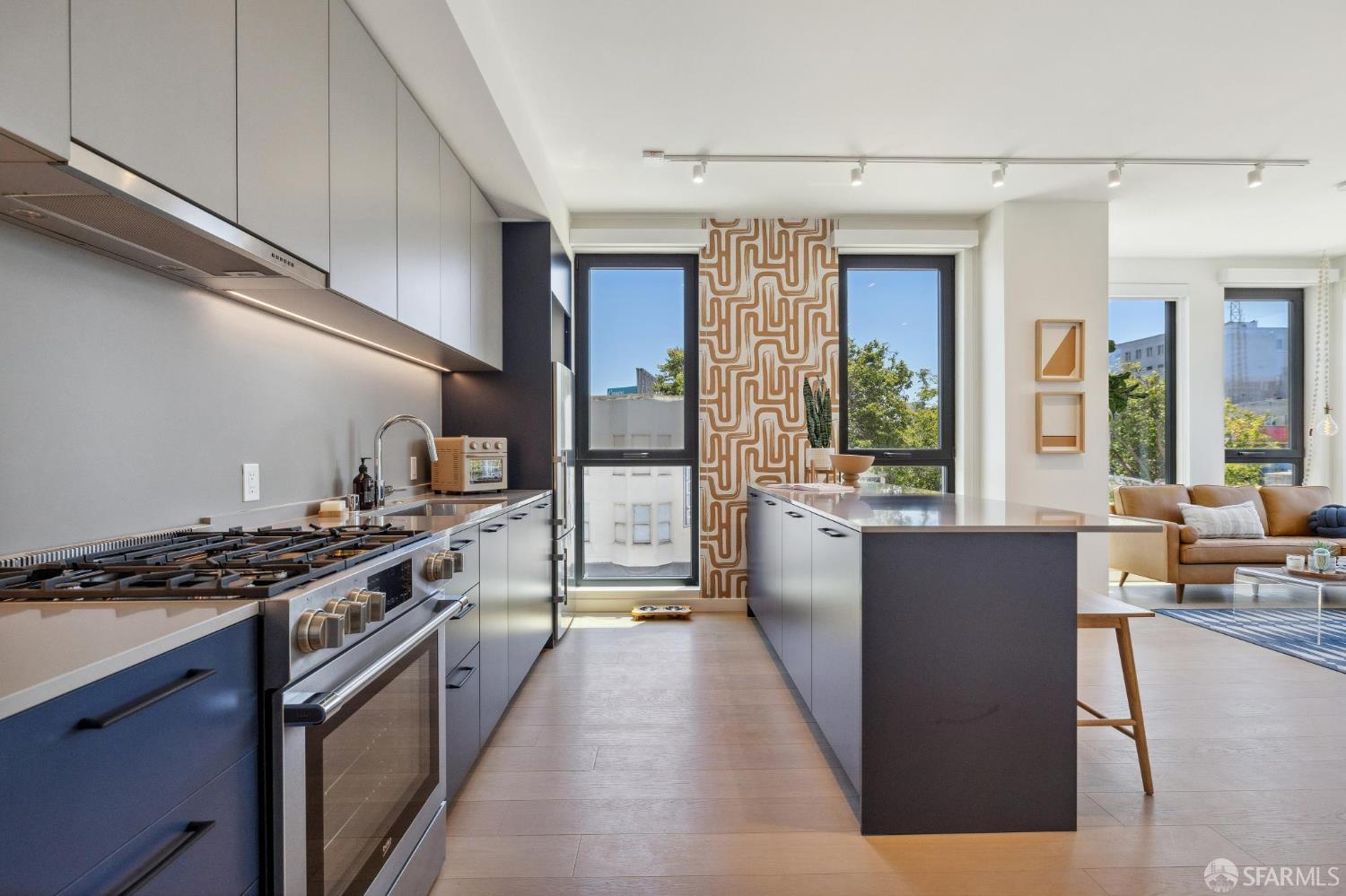 988 Harrison Street, Unit 707 San Francisco, CA 94107 - Photo 5 of 24 a kitchen with stainless steel appliances granite countertop a stove a sink and a refrigerator