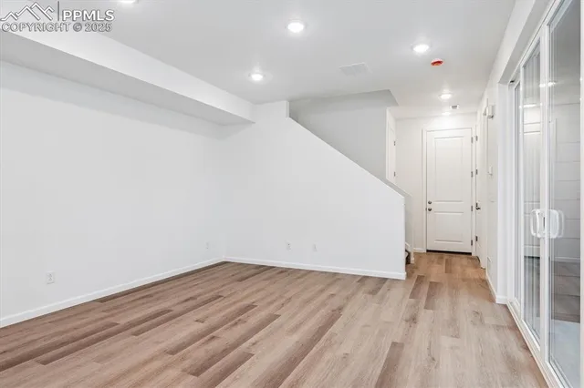 a view of hallway with wooden floor