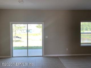 5370 Kellar Circle Jacksonville, FL 32218 - Photo 13 of 21 an empty room with wooden floor and windows