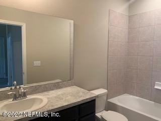 5370 Kellar Circle Jacksonville, FL 32218 - Photo 18 of 21 a bathroom with a granite countertop sink a toilet and shower