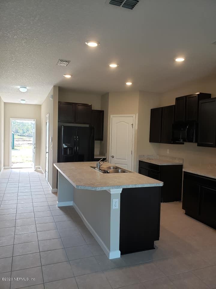 5370 Kellar Circle Jacksonville, FL 32218 - Photo 2 of 21 a large kitchen with stainless steel appliances a large counter top and a stove