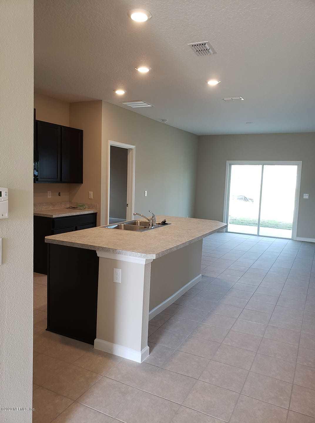 5370 Kellar Circle Jacksonville, FL 32218 - Photo 5 of 21 a large white kitchen with a sink and a large window