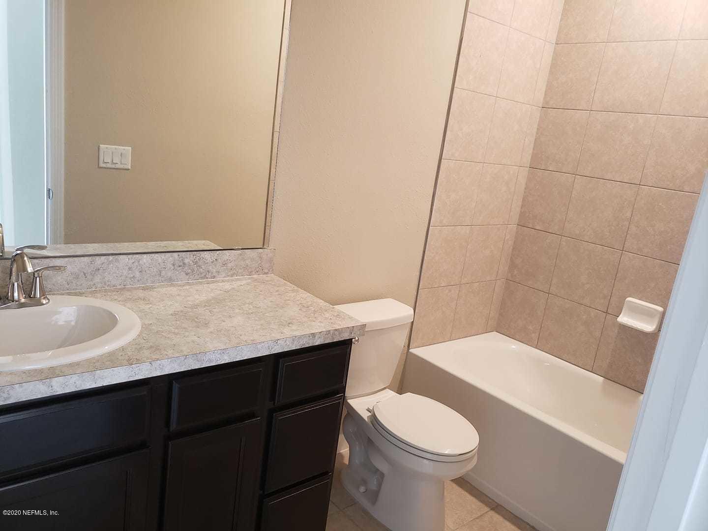 5370 Kellar Circle Jacksonville, FL 32218 - Photo 10 of 21 a bathroom with a granite countertop toilet sink and mirror