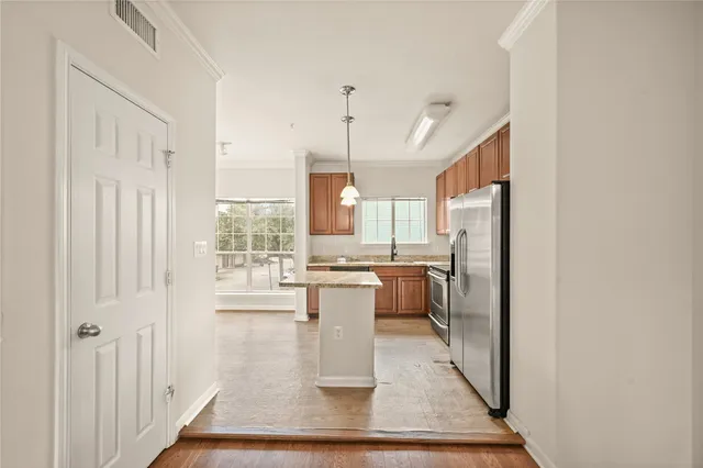 a kitchen with a granite countertop sink and window