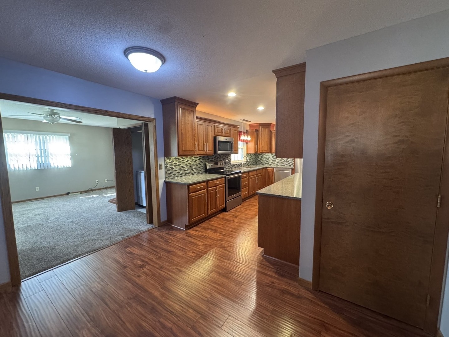 805 Keith Street Morrison, IL 61270 - Photo 12 of 33 a large kitchen with stainless steel appliances granite countertop a refrigerator and a stove top oven