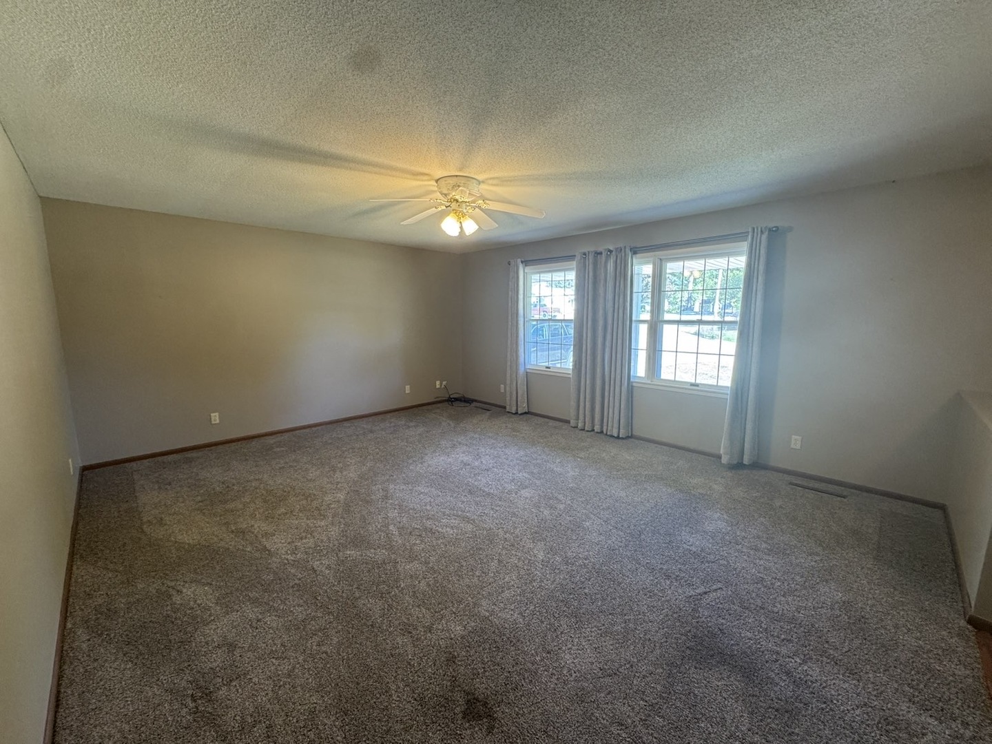 805 Keith Street Morrison, IL 61270 - Photo 19 of 33 an empty room with windows and ceiling fan