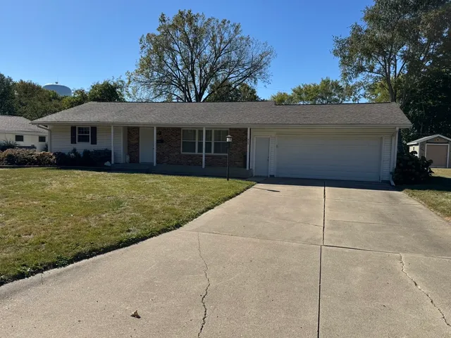 a front view of house with yard and trees