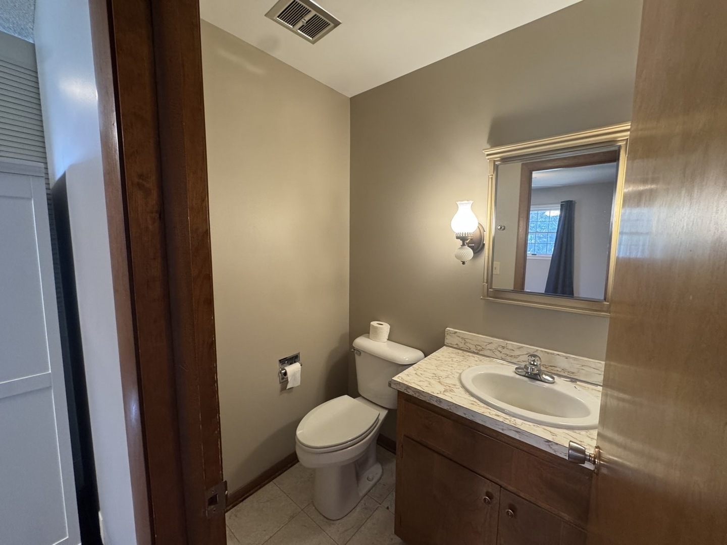 805 Keith Street Morrison, IL 61270 - Photo 25 of 33 a bathroom with a sink a toilet and mirror