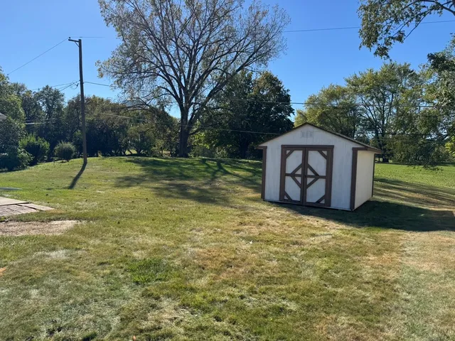 a view of a backyard with large trees