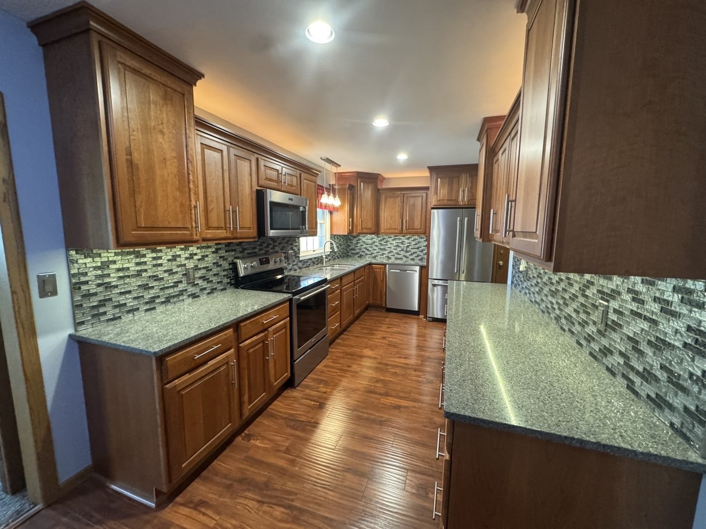 805 Keith Street Morrison, IL 61270 - Photo 10 of 33 a kitchen with stainless steel appliances granite countertop a stove a sink and a refrigerator