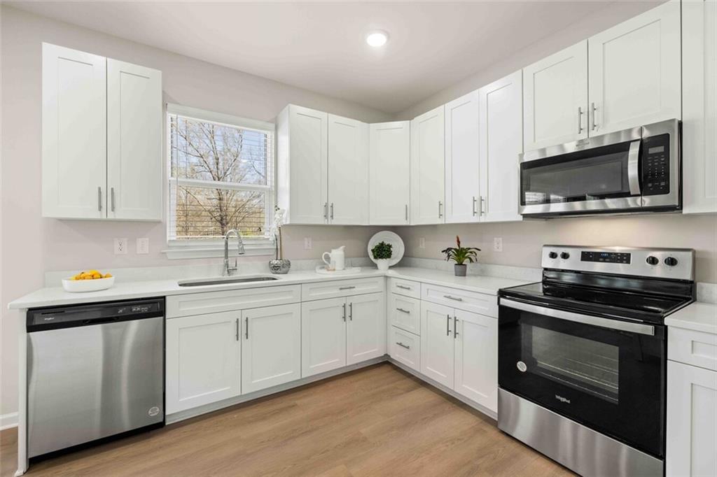 3489 Fairview Road, Unit MAGNOLIA Covington, GA 30016 - Photo 7 of 29 a kitchen with appliances a sink and cabinets