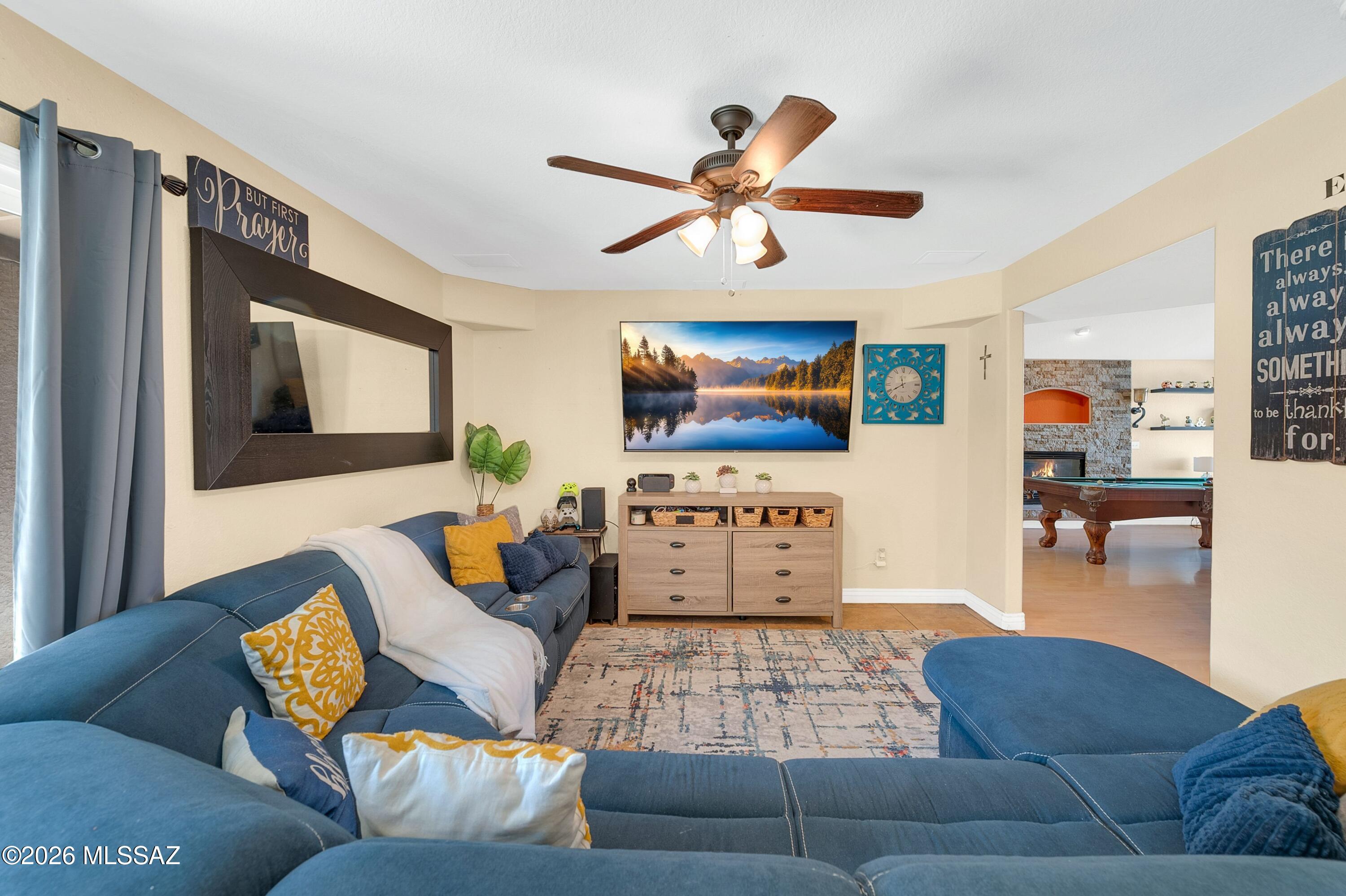 7159 West Maple Ridge Drive Tucson, AZ 85743 - Photo 9 of 42 a living room with furniture and a flat screen tv