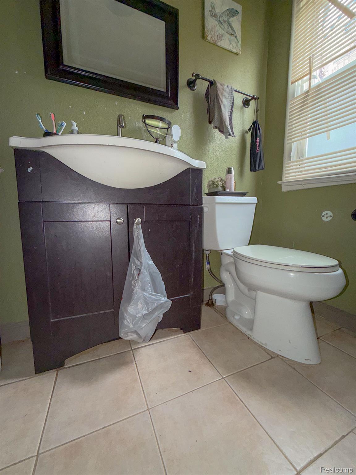 24811 Valley Avenue Eastpointe, MI 48021 - Photo 9 of 22 Bathroom with vanity and light tile patterned flooring