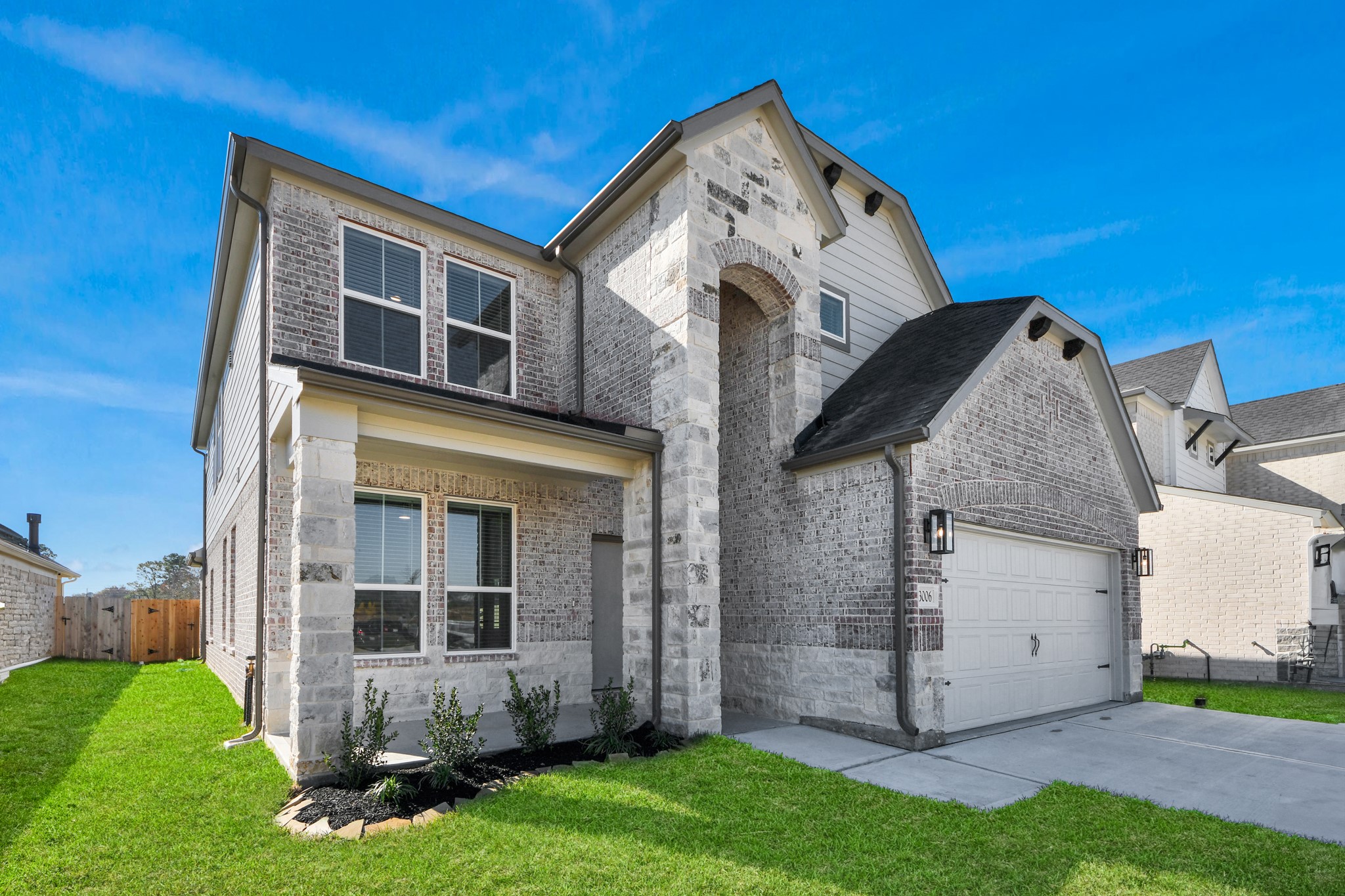 3006 Burris Park Drive Spring, TX 77373 - Photo 2 of 45 The residence features a practical 2-car garage complemented by a generous driveway, ensuring abundant space for parking needs.