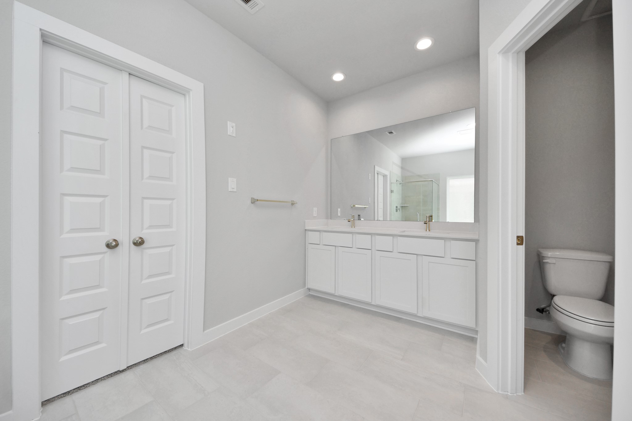 3006 Burris Park Drive Spring, TX 77373 - Photo 26 of 45 Elevate your daily routine at the elegant vanity, now equipped with double sinks, light countertops, modern hardware, and beautiful recessed lights.
