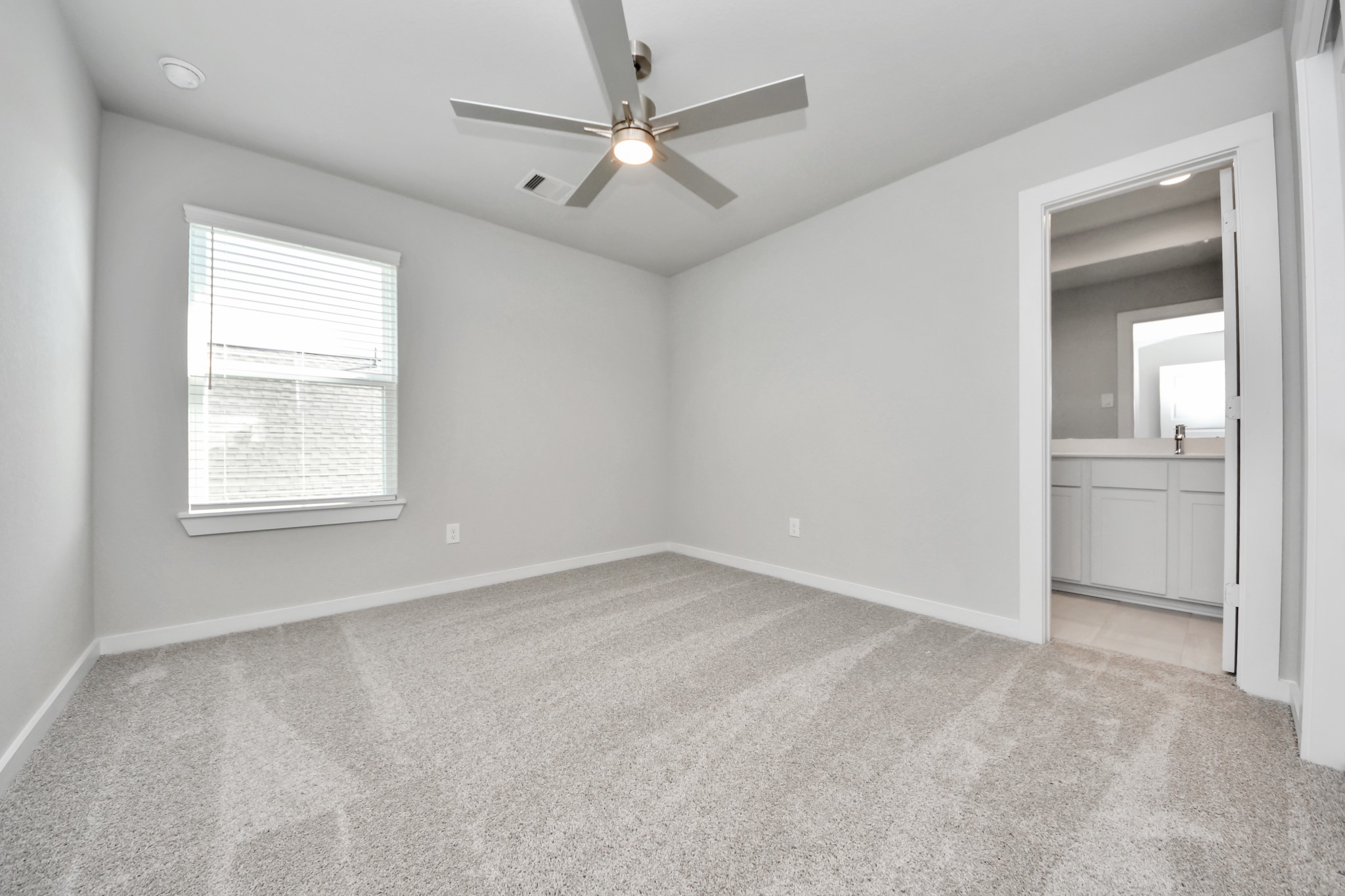 3006 Burris Park Drive Spring, TX 77373 - Photo 34 of 45 an empty room with a window and a ceiling fan