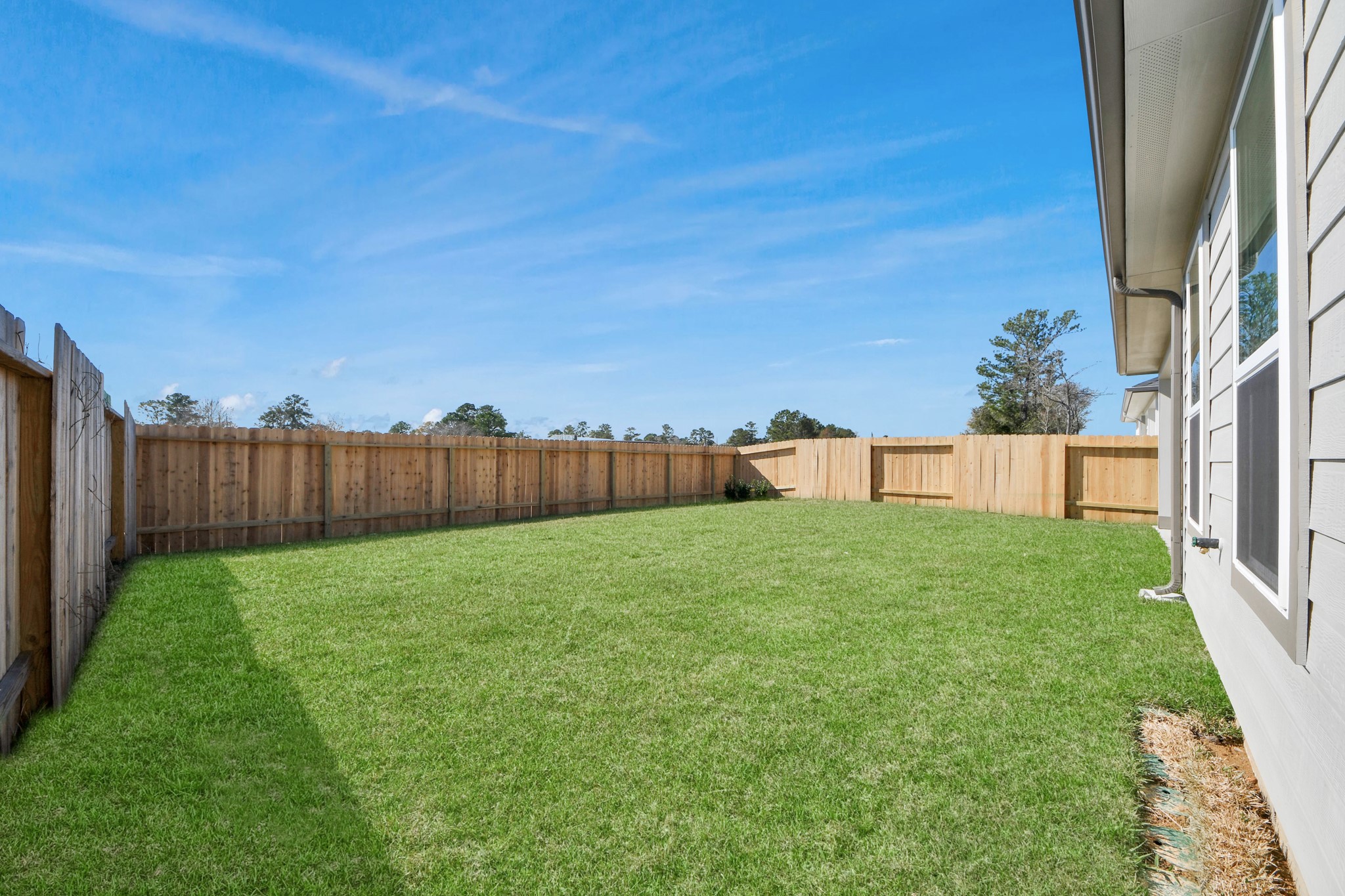 3006 Burris Park Drive Spring, TX 77373 - Photo 43 of 45 Explore the expansive backyard with its inviting covered patio—a perfect blend of space for the kids to play and adults to unwind. Ideal for creating your outdoor oasis, this backyard accommodates patio furniture, a BBQ pit, and endless possibilities for leisure and entertainment.