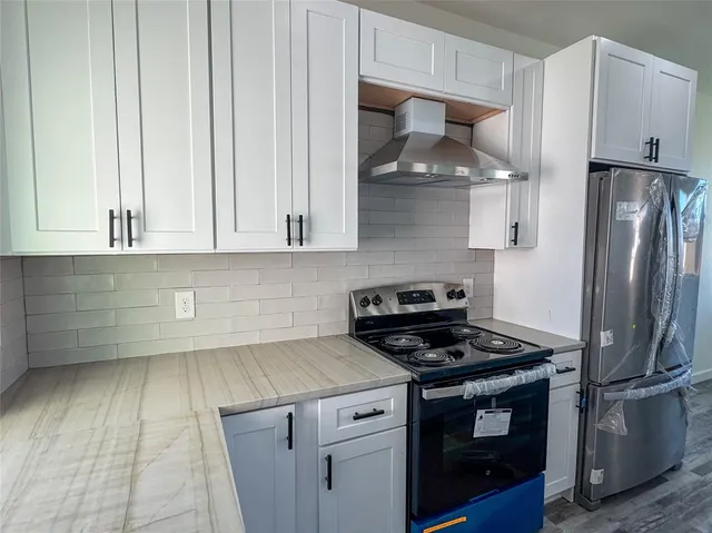 a kitchen with stainless steel appliances a stove and a refrigerator