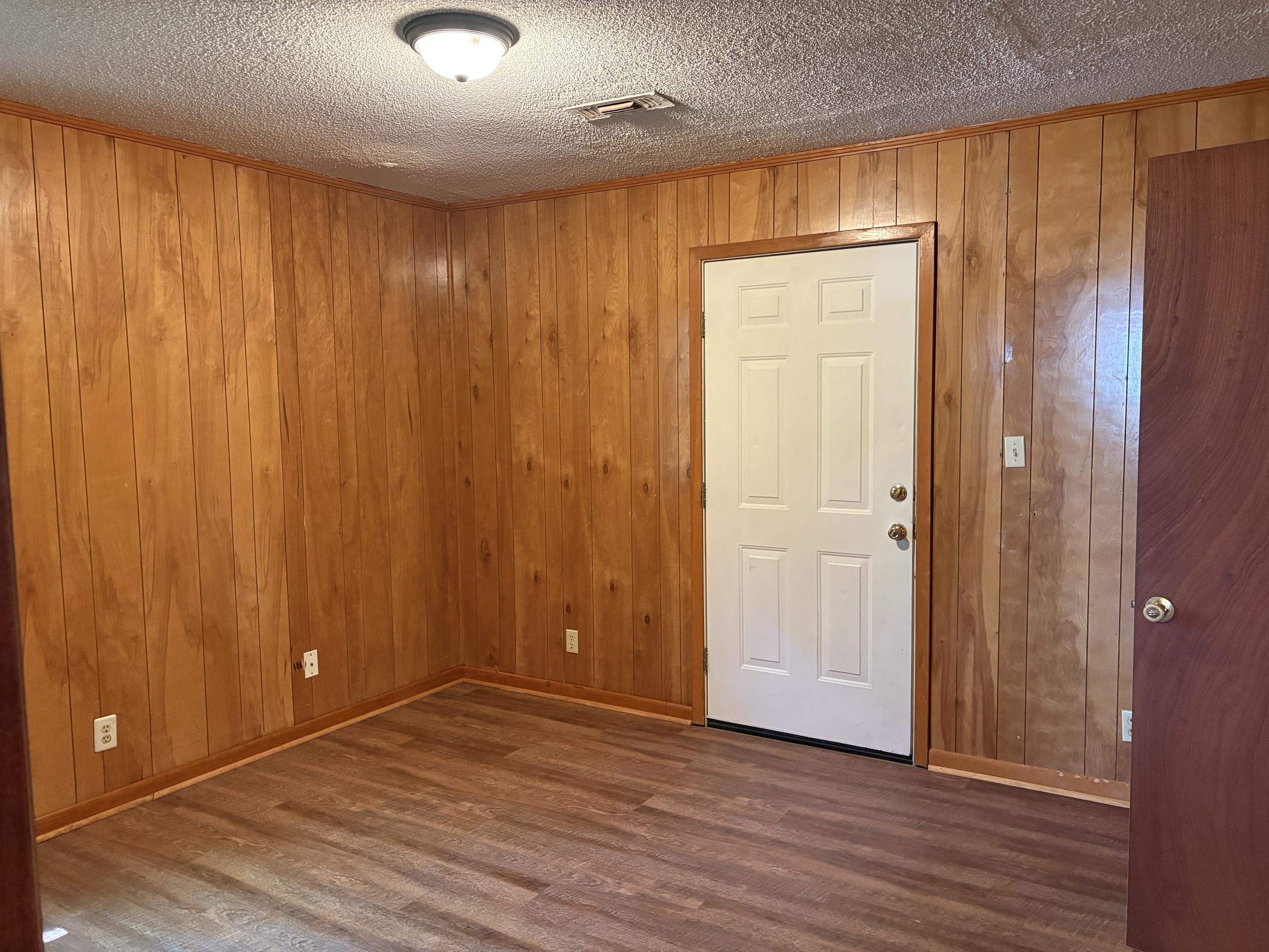 146 Walker Street Ripley, TN 38063 - Photo 11 of 14 an empty room with wooden floor and closet area