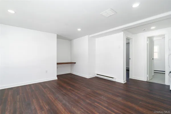 an empty room with wooden floor