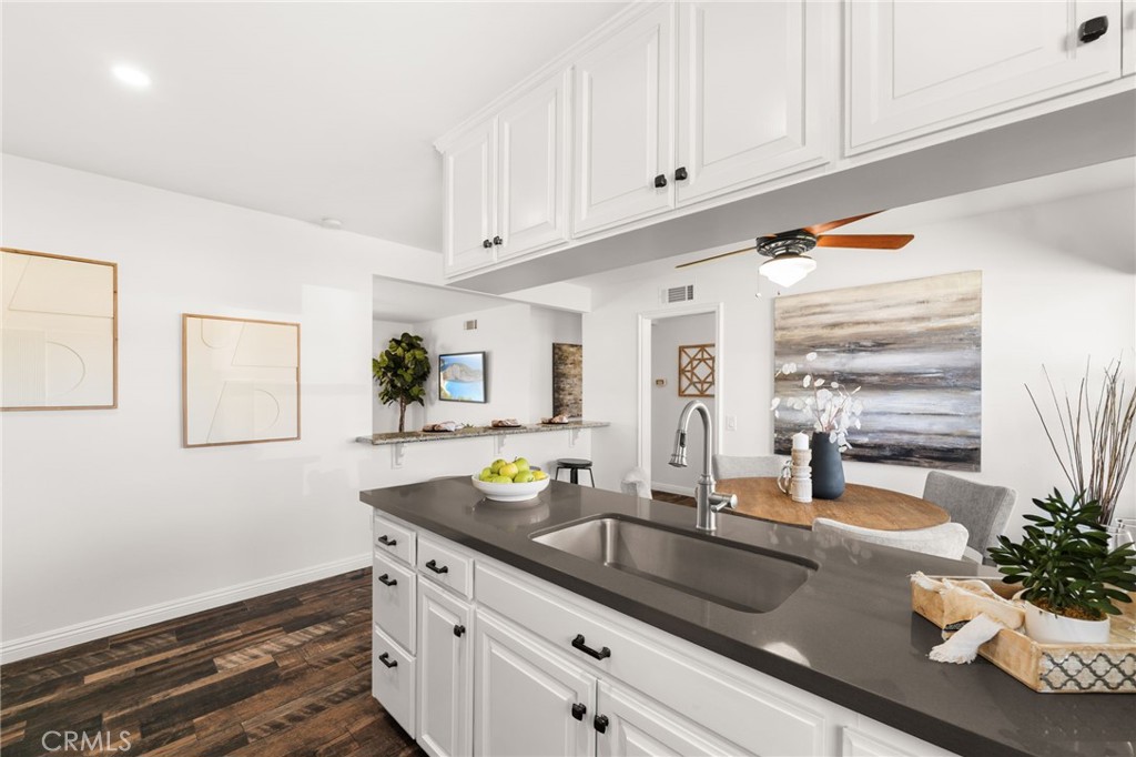 6661 Yucca Avenue Rialto, CA 92376 - Photo 11 of 44 a kitchen with granite countertop a sink and white cabinets