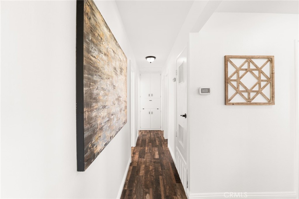 6661 Yucca Avenue Rialto, CA 92376 - Photo 18 of 44 a view of a hallway with wooden floor and a bathroom