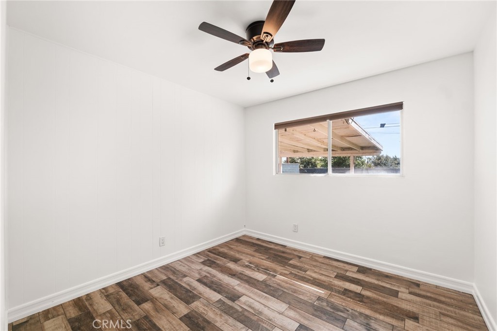 6661 Yucca Avenue Rialto, CA 92376 - Photo 23 of 44 an empty room with a window and a ceiling fan