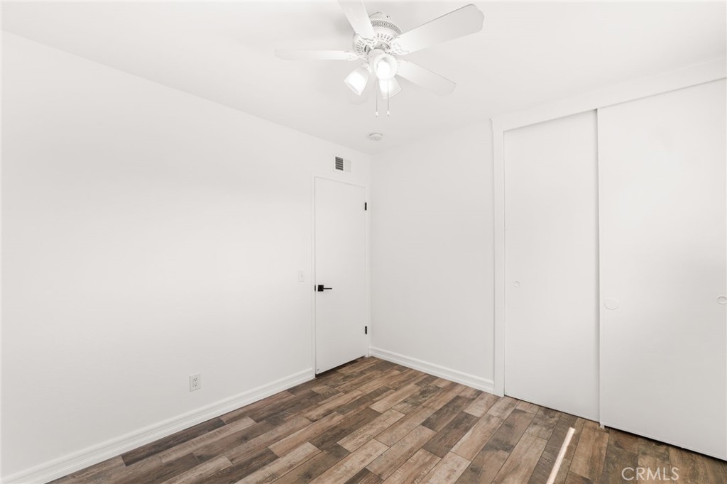 6661 Yucca Avenue Rialto, CA 92376 - Photo 27 of 44 an empty room with a ceiling fan and a window