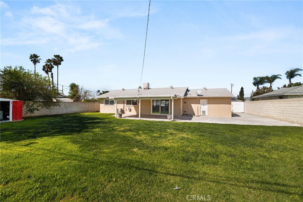 6661 Yucca Avenue Rialto, CA 92376 - Photo 30 of 44 a view of a house with a yard and sitting area