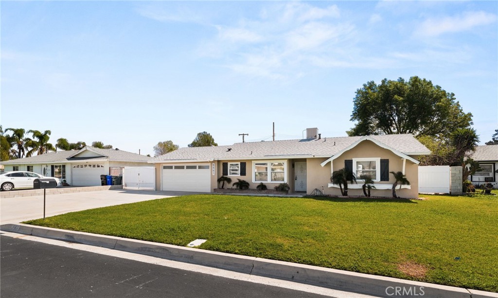 6661 Yucca Avenue Rialto, CA 92376 - Photo 3 of 44 a front view of a house with a yard table and chairs