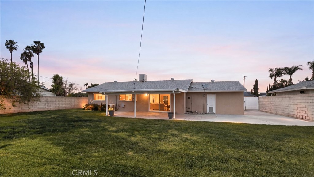 6661 Yucca Avenue Rialto, CA 92376 - Photo 37 of 44 a front view of a house with a garden and lake view