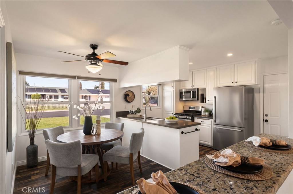 6661 Yucca Avenue Rialto, CA 92376 - Photo 6 of 44 a kitchen with a dining table and chairs