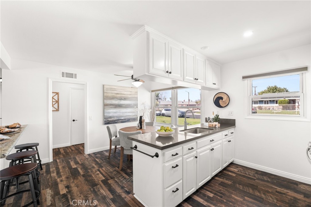 6661 Yucca Avenue Rialto, CA 92376 - Photo 8 of 44 a kitchen with appliances cabinets and a table